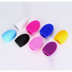 A set of silicone makeup brush cleaners in various colours: white, blue, black, pink, purple, and yellow.
