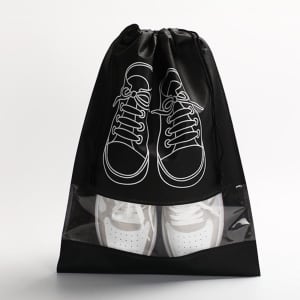 A black non-woven drawstring bag featuring a clear window, displaying white sneakers with a design of shoes on the front.