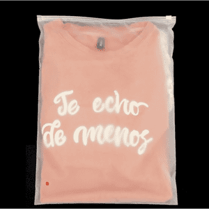 A pink t-shirt with white text is packaged in a clear, waterproof zip-lock storage bag.
