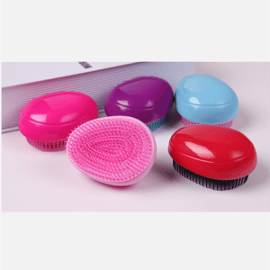 Five egg-shaped combs in various colours: pink, red, blue, purple, and a contrasting black base.