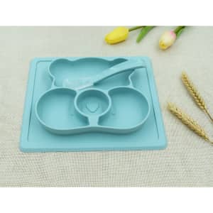 A non-slip children's plate in teal, featuring three compartments and a matching spoon, with a floral background.