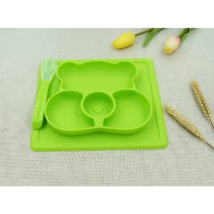 A green, bear-shaped non-slip children's plate with three compartments and a matching spoon.