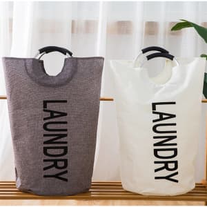 A portable laundry basket in grey and white, featuring a sturdy handle and the word "LAUNDRY" printed on the front.