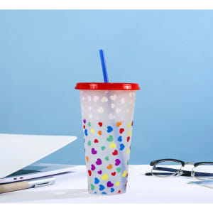 A drink bottle with a red lid and straw, featuring a clear body decorated with colourful heart patterns.