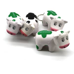A set of four white and green milk cow stress key chains, each with a keyring and a logo.