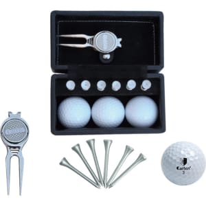 A golf set featuring three white golf balls, tees, a pitch fork, and a black case with a logo.