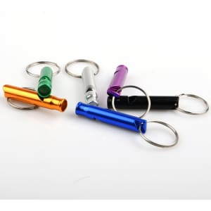 A set of portable aluminium whistles in orange, silver, purple, green, black, and blue, attached to keyrings.