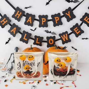 A cream reusable canvas tote bag featuring Halloween-themed designs, with pumpkins and decorations, alongside orange pumpkins.