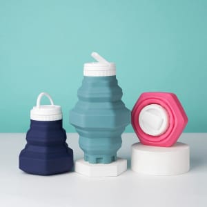 A drink bottle collection featuring collapsible designs in blue, navy, pink, and white, with various shapes and caps.