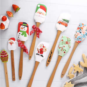 A set of festive baking spatulas featuring Christmas designs, including a snowman, Santa, and holiday patterns, with wooden handles.