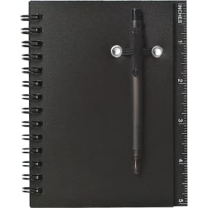 A black spiral notebook with a pen attached, featuring a ruler along the edge.