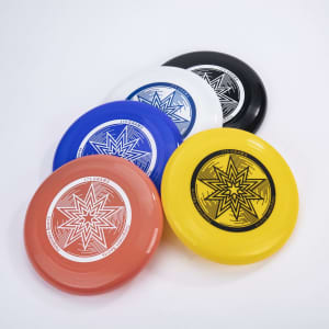 A set of five Ultimate Frisbees in red, blue, white, black, and yellow, featuring a star design and a logo.