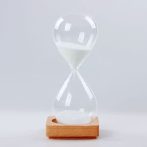 A five-minute sand timer with a wooden base and transparent glass hourglass. White sand is visible inside.