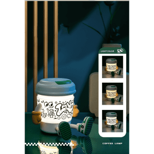 A coffee cup-shaped lamp and Bluetooth speaker in white and green, featuring playful doodle art, sits on a reflective surface.