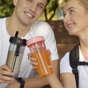 A drink bottle with a compartmentalised design, featuring a pink and black colour scheme, and includes double drinking straws.