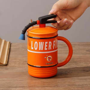 A drink mug in the shape of a fire extinguisher, featuring an orange body and a black handle with a nozzle.