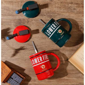 A drink mug in the shape of a fire extinguisher, featuring red and green colours and a logo.
