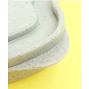 A wheat straw bread box in a soft grey-green colour with a speckled texture. It features a smooth, curved design.
