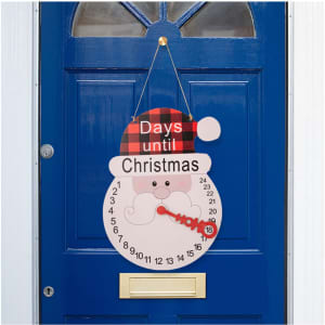 A decorative Christmas calendar ornament featuring a snowman design with red and black plaid, hanging on a blue door.