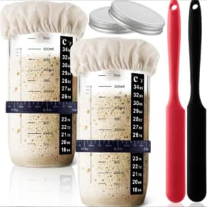 A 32 oz. Mason fermenter jar set with measuring markings, two lids, and silicone spatulas in red and black.