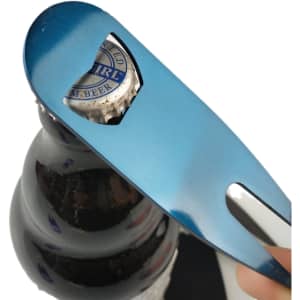 A drink bottle opener tool in metallic blue is removing a bottle cap from a dark glass bottle.