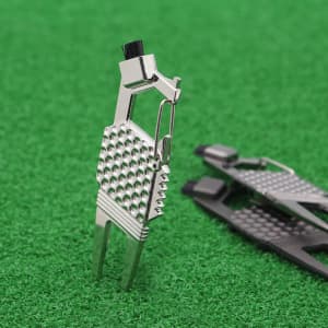A silver 7-in-1 golf tool featuring various functions, set against a green grass background.