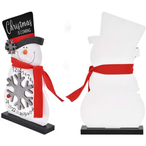 A festive white snowman ornament with a black hat and red scarf, featuring a countdown calendar and snowflake detail.