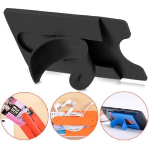 A black silicone phone stand and smart wallet card holder featuring a curved back and an orange attachment.