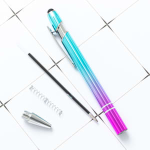 Incline Soft Touch Stylus Metal Pen in gradient blue and pink, with a detachable stylus tip and ink cartridge.