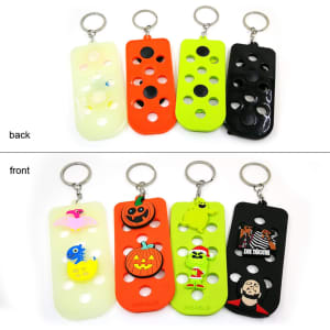 A collection of colourful Clog Charm Keychains, featuring various designs and characters on both sides, including orange, green, and black.