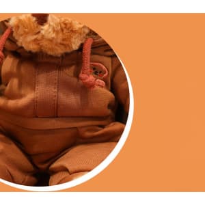 A brown plush teddy bear wearing a matching brown outfit, featuring a small logo on the clothing.