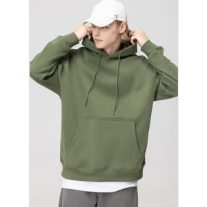 A hooded sweatshirt in olive green, featuring a front pocket and drawstrings. The model wears a white cap.