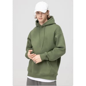 A hooded sweatshirt in olive green, featuring a front kangaroo pocket and drawstrings. The model wears a white cap.