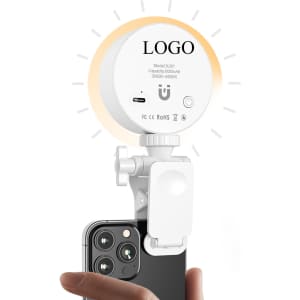 A compact white lighting kit attaches to a smartphone, featuring adjustable brightness and a minimalistic design.