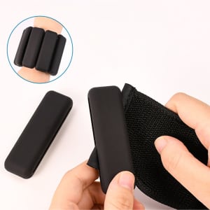A silicone weighted bracelet with three black weights, being held and adjusted on a wrist.