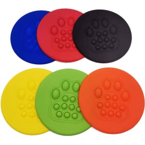 A set of pet flying discs in blue, red, yellow, green, black, and orange, each featuring a paw print design.