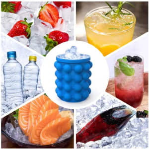 A blue silicone ice cube maker and bucket surrounded by various drinks and food items on ice.
