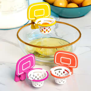 A set of mini basketball hoop separators in pink, orange, and yellow, placed near a bowl of egg yolks.