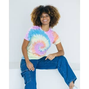 A tie dye adult t-shirt featuring pastel shades of pink, blue, yellow, and orange, displayed by a model.