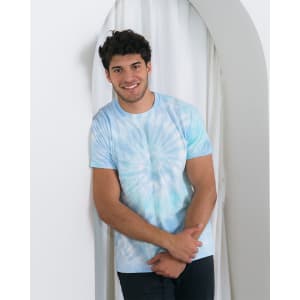 A light blue tie-dye adult T-shirt displayed on a model against a neutral backdrop, featuring a logo.