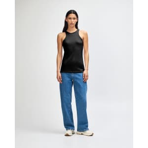 A black racerneck tank top with a fitted design, worn with light blue cargo pants and styled with black and white sneakers.