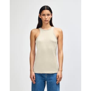 A lightweight, cream-coloured women's racerneck tank top with a fitted design and branding.