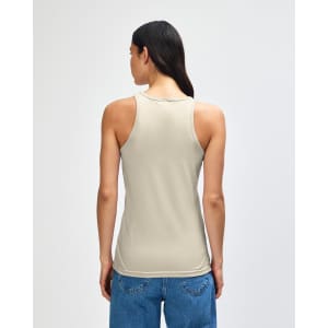 A women's racerneck tank in beige, featuring a logo on the back and a fitted silhouette.