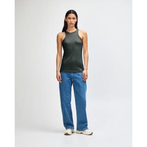 A woman wearing a dark green American Apparel CVC racerneck tank top paired with light blue cargo pants.