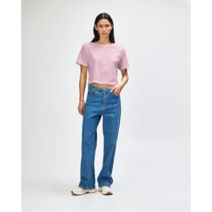 A women's fine jersey boxy T-shirt in soft pink, paired with light blue wide-leg jeans and white sneakers.