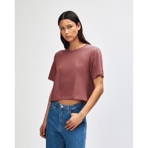 A model wears a dusty rose American Apparel women's fine jersey boxy T-shirt, featuring a relaxed fit and short sleeves.