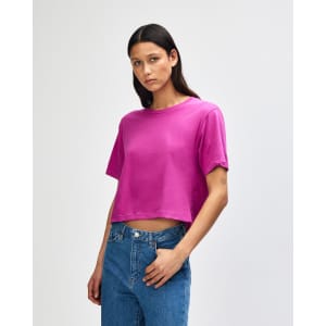 A women's fine jersey boxy t-shirt in vibrant pink, featuring short sleeves and relaxed fit. It has a logo.