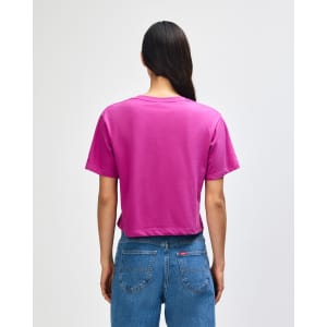 A women's fine jersey boxy T-shirt in magenta colour, featuring a plain back design. The model wears denim jeans.