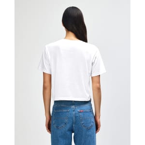 A white women's boxy t-shirt from American Apparel, featuring a plain back, paired with denim jeans.
