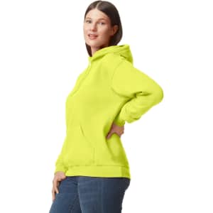 A bright yellow hooded sweatshirt with a front pocket and a logo, worn by a woman.